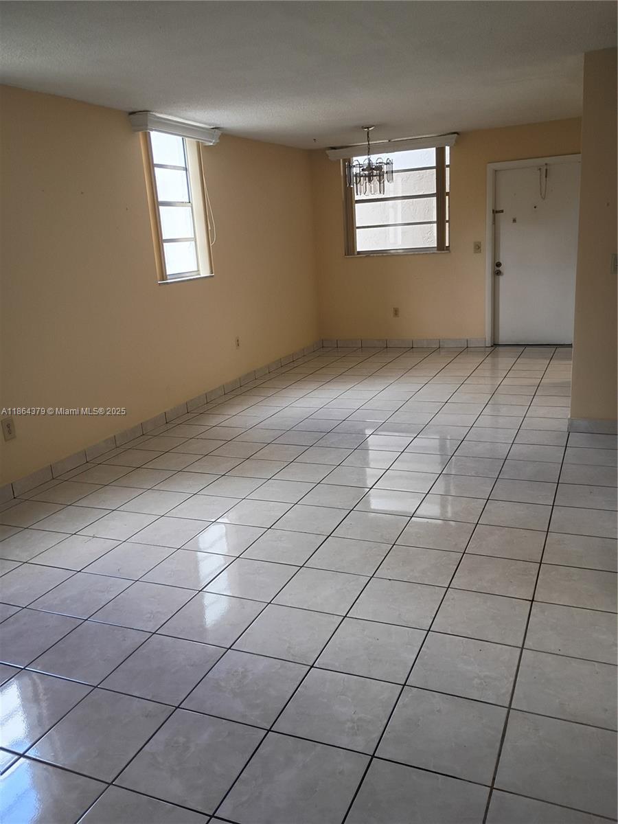 14165 Southwest 87th Street, Unit D103 Miami, FL 33183 - Photo 27 of 41 a view of an empty room and window