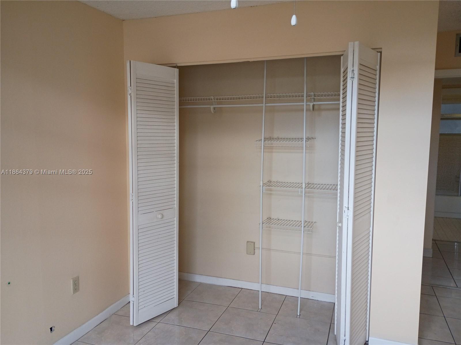 14165 Southwest 87th Street, Unit D103 Miami, FL 33183 - Photo 29 of 41 a view of an empty walk in closet