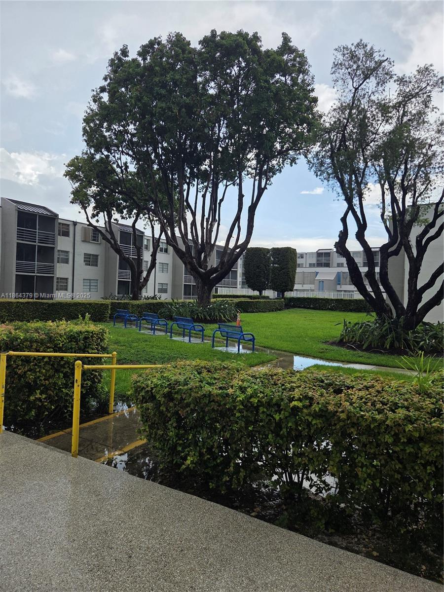 14165 Southwest 87th Street, Unit D103 Miami, FL 33183 - Photo 4 of 41 a view of a field with large trees