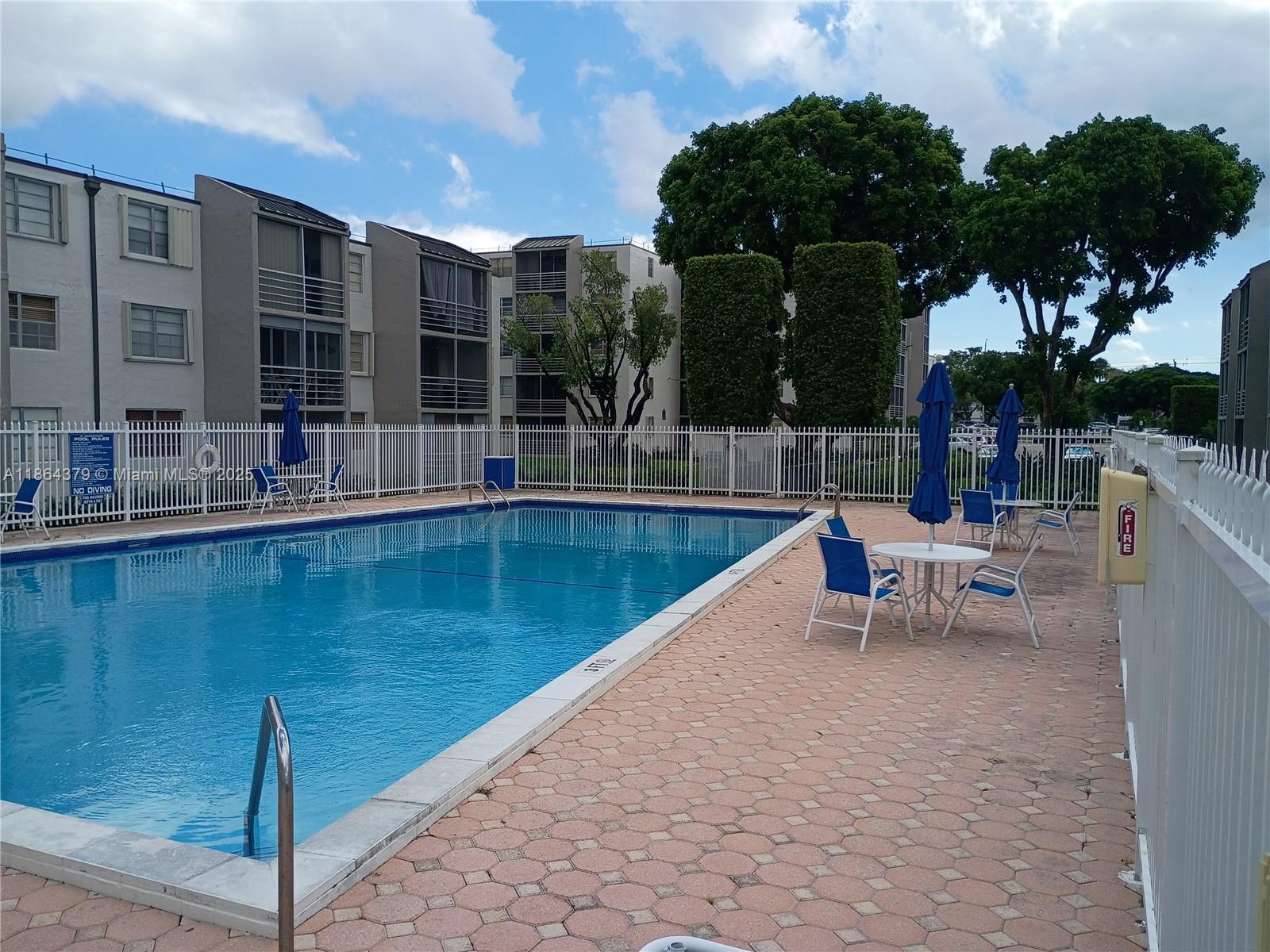 14165 Southwest 87th Street, Unit D103 Miami, FL 33183 - Photo 10 of 41 a view of swimming pool with outdoor seating