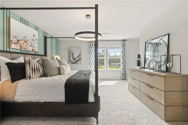 a living room with furniture and a painting on the wall