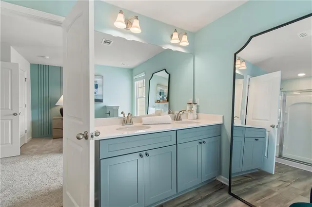 a spacious bathroom with a double vanity sink and a mirror