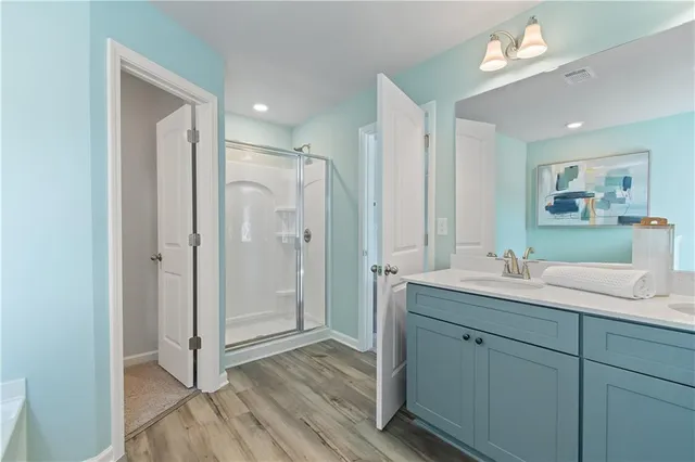 a bathroom with a double vanity sink mirror and shower