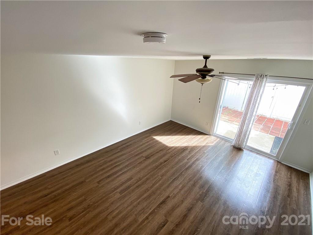 750 Elders Story Road Fort Mill, SC 29708 - Photo 6 of 24 an empty room with wooden floor fan and windows