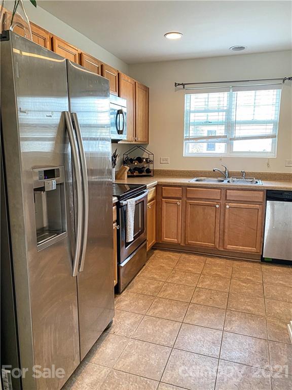 750 Elders Story Road Fort Mill, SC 29708 - Photo 7 of 24 a kitchen with stainless steel appliances granite countertop a sink stove and refrigerator