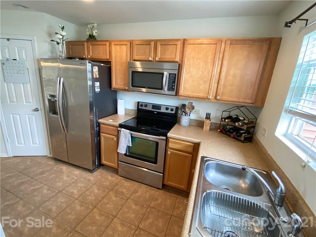 750 Elders Story Road Fort Mill, SC 29708 - Photo 8 of 24 a kitchen with granite countertop a refrigerator a stove a sink and dishwasher