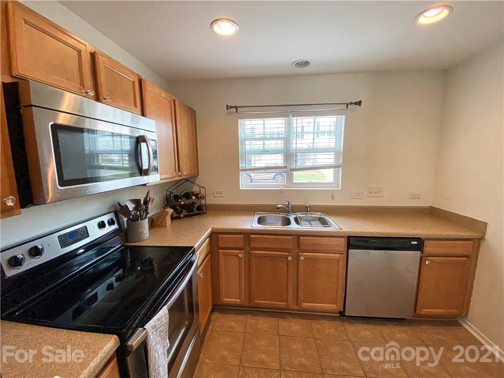 750 Elders Story Road Fort Mill, SC 29708 - Photo 9 of 24 a kitchen with stainless steel appliances a sink stove and microwave