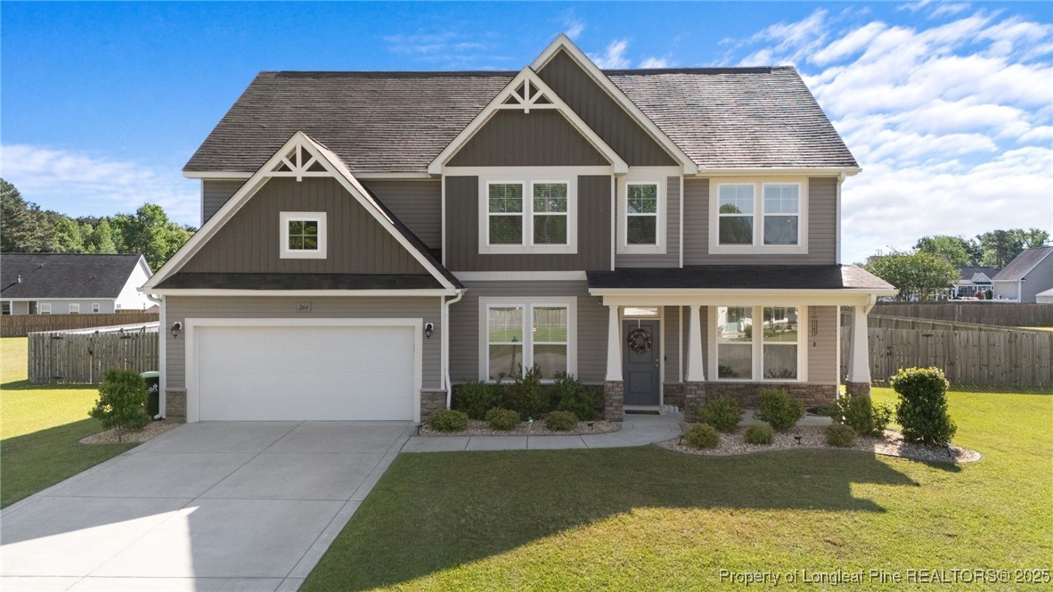 264 Mill Ridge Court Godwin, NC 28344 - Photo 1 of 43 a front view of a house with garden