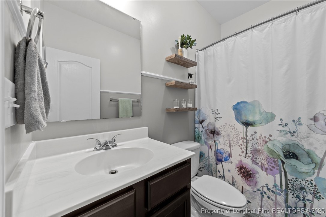 264 Mill Ridge Court Godwin, NC 28344 - Photo 14 of 43 a bathroom with a sink vanity mirror and toilet