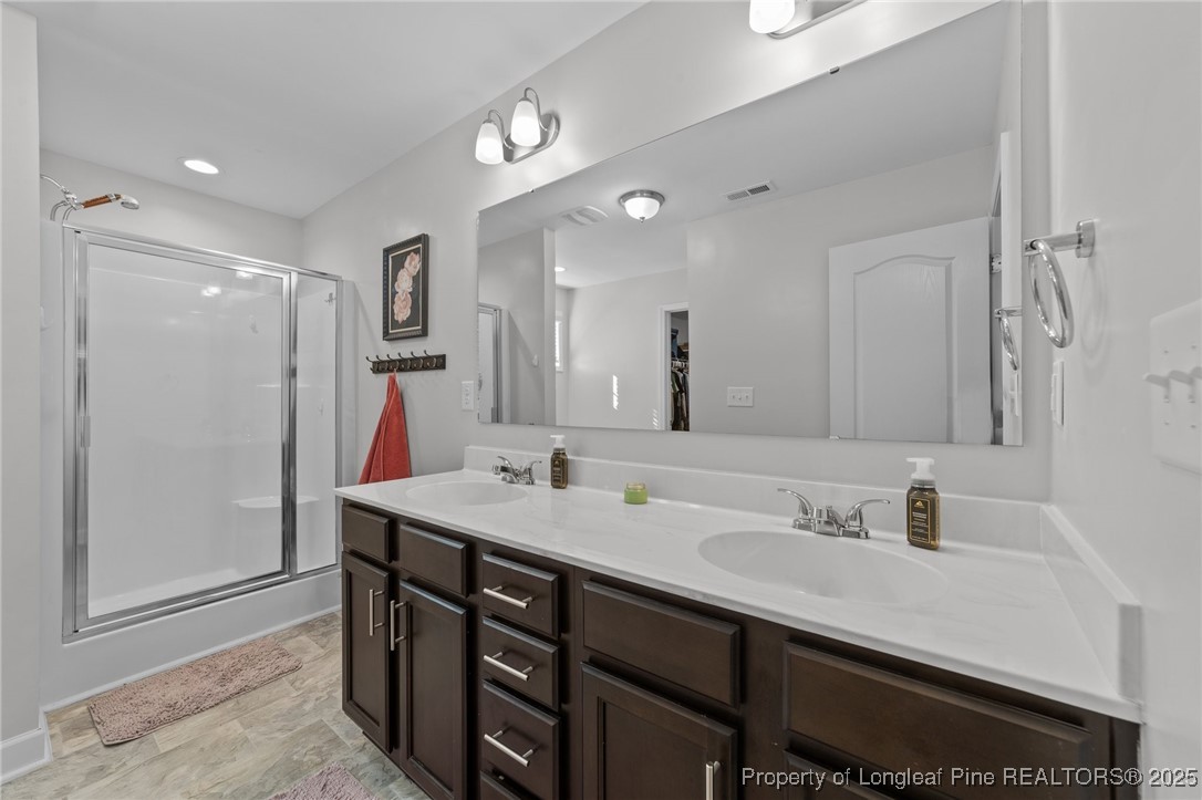 264 Mill Ridge Court Godwin, NC 28344 - Photo 20 of 43 a bathroom with a sink double vanity and a mirror