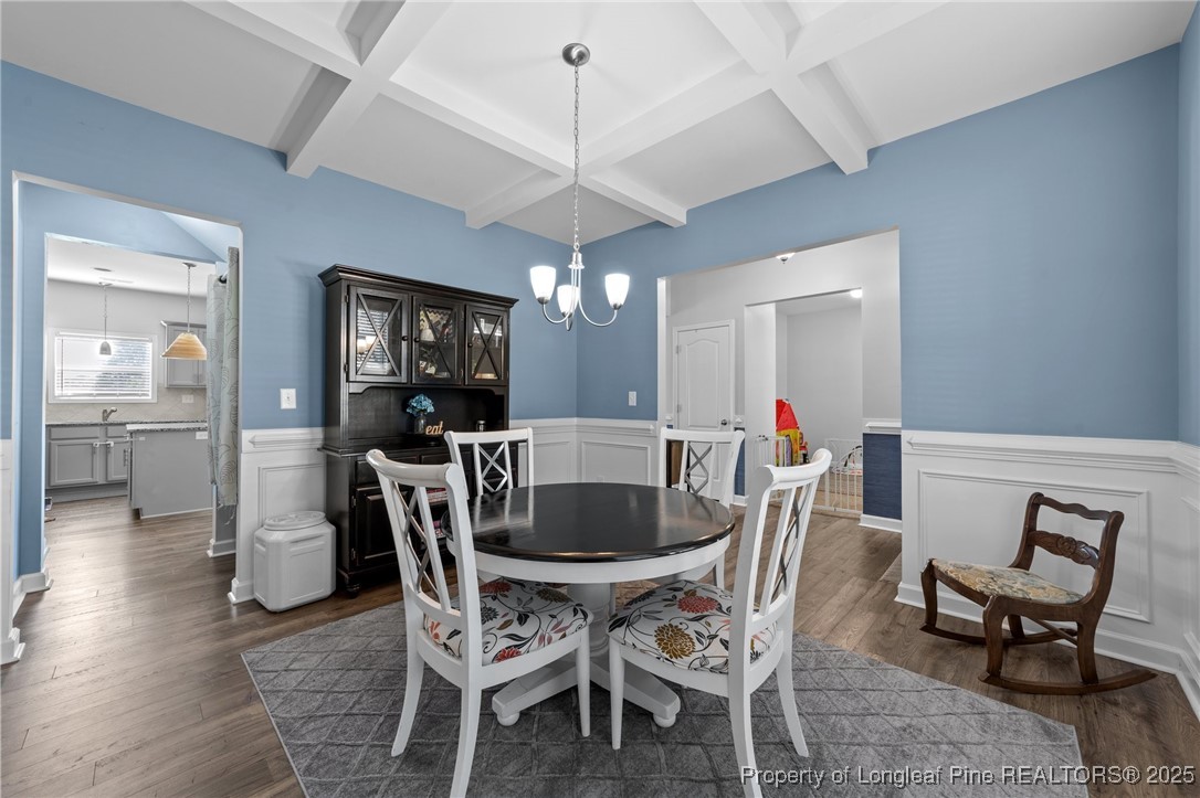 264 Mill Ridge Court Godwin, NC 28344 - Photo 5 of 43 a dining room with furniture a chandelier and wooden floor