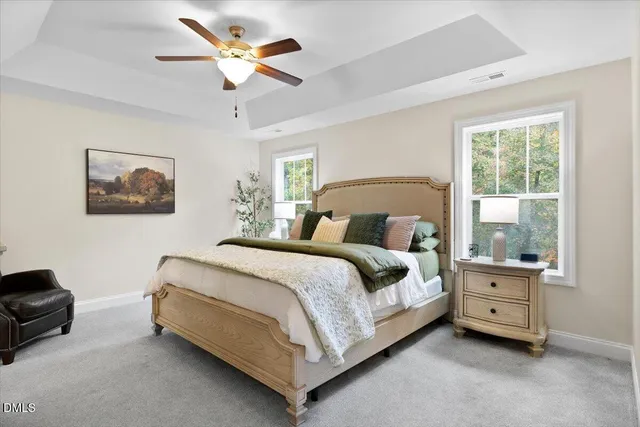 a bedroom with a bed a couch and a window