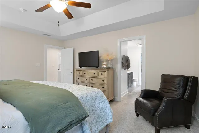 a bedroom with a bed and a television