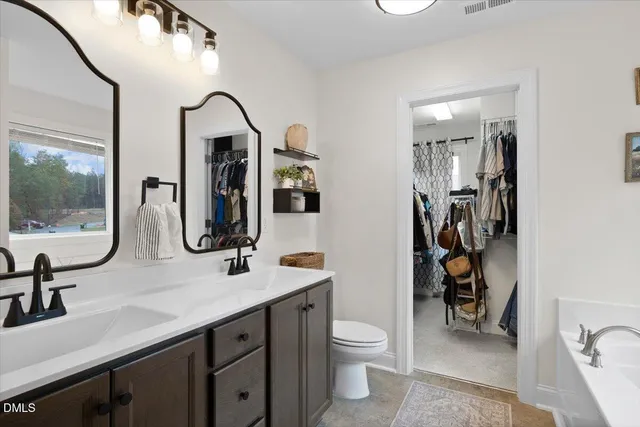 a en suite bathroom with a sink a toilet and a mirror