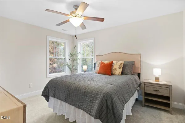 a bedroom with a bed and a ceiling fan