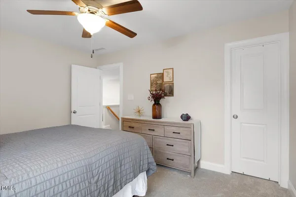 a bedroom with a bed and a dresser