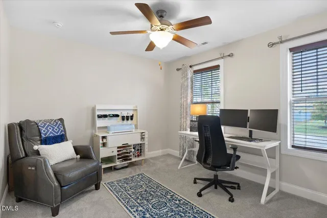 a view of a workspace with furniture and a window
