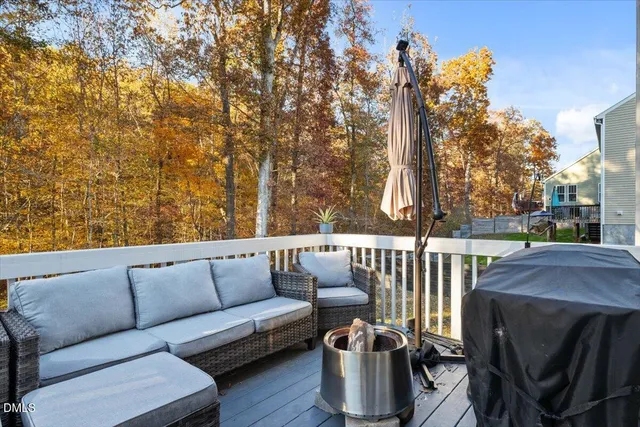 a roof deck with couches and wooden fence