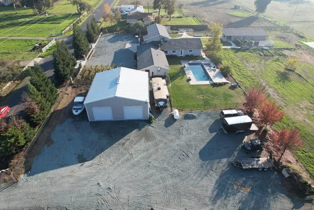 an aerial view of a house with a yard