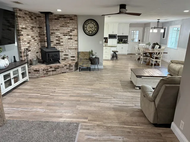 a living room with fireplace furniture and a flat screen tv
