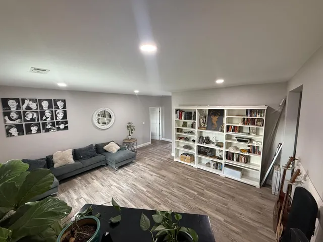 a living room with furniture and wooden floor