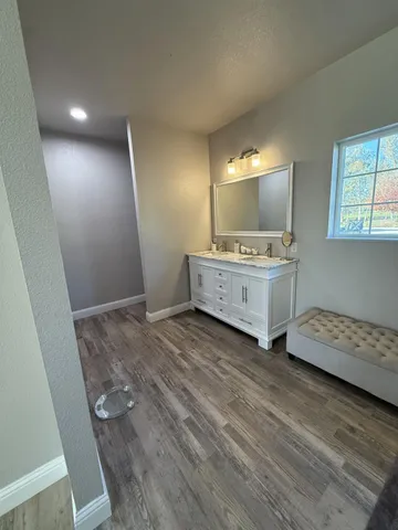 a spacious bathroom with a double vanity sink and a mirror