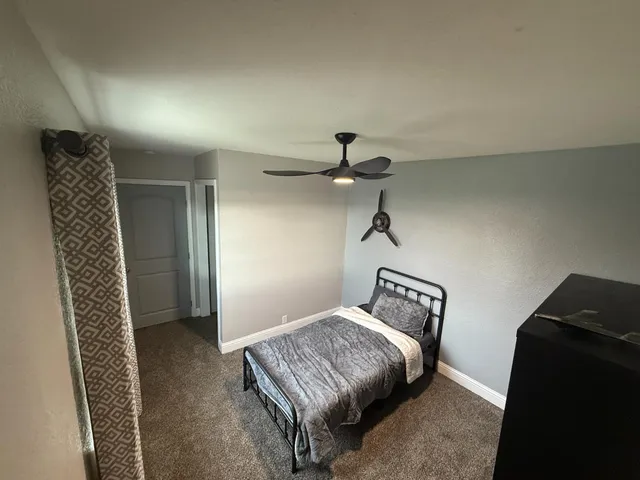 a bedroom with a bed and window