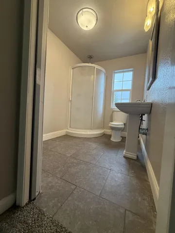 a kitchen with a sink a stove a refrigerator and cabinets