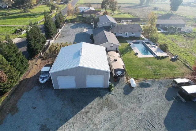 an aerial view of a house with a yard basket ball court and outdoor seating