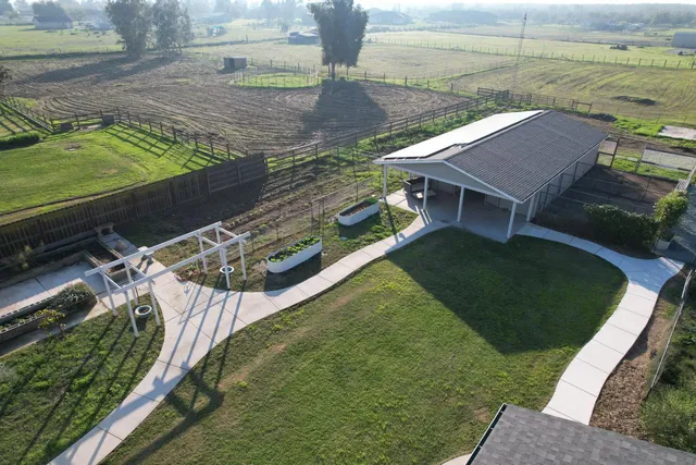 a view of a backyard with lawn chairs