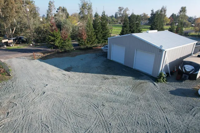 a view of a house with a yard and trees