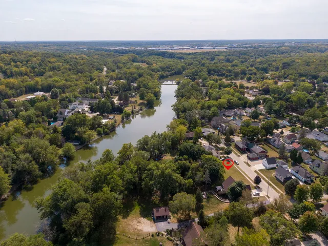 an aerial view of town with residential houses with outdoor space and trees