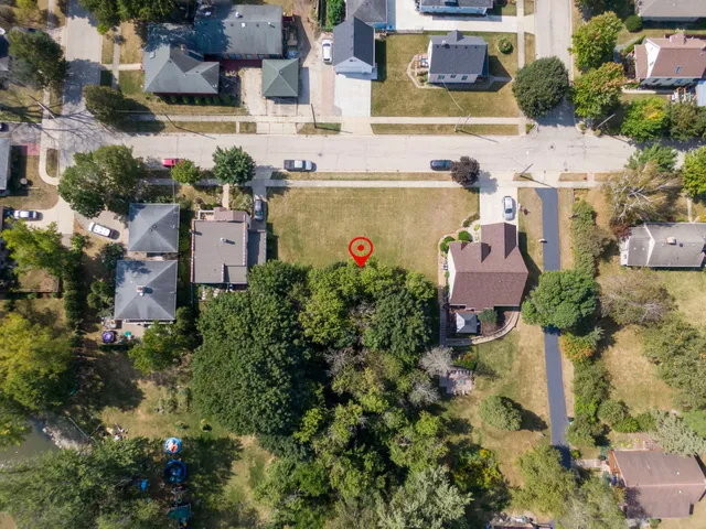 an aerial view of a houses with yard