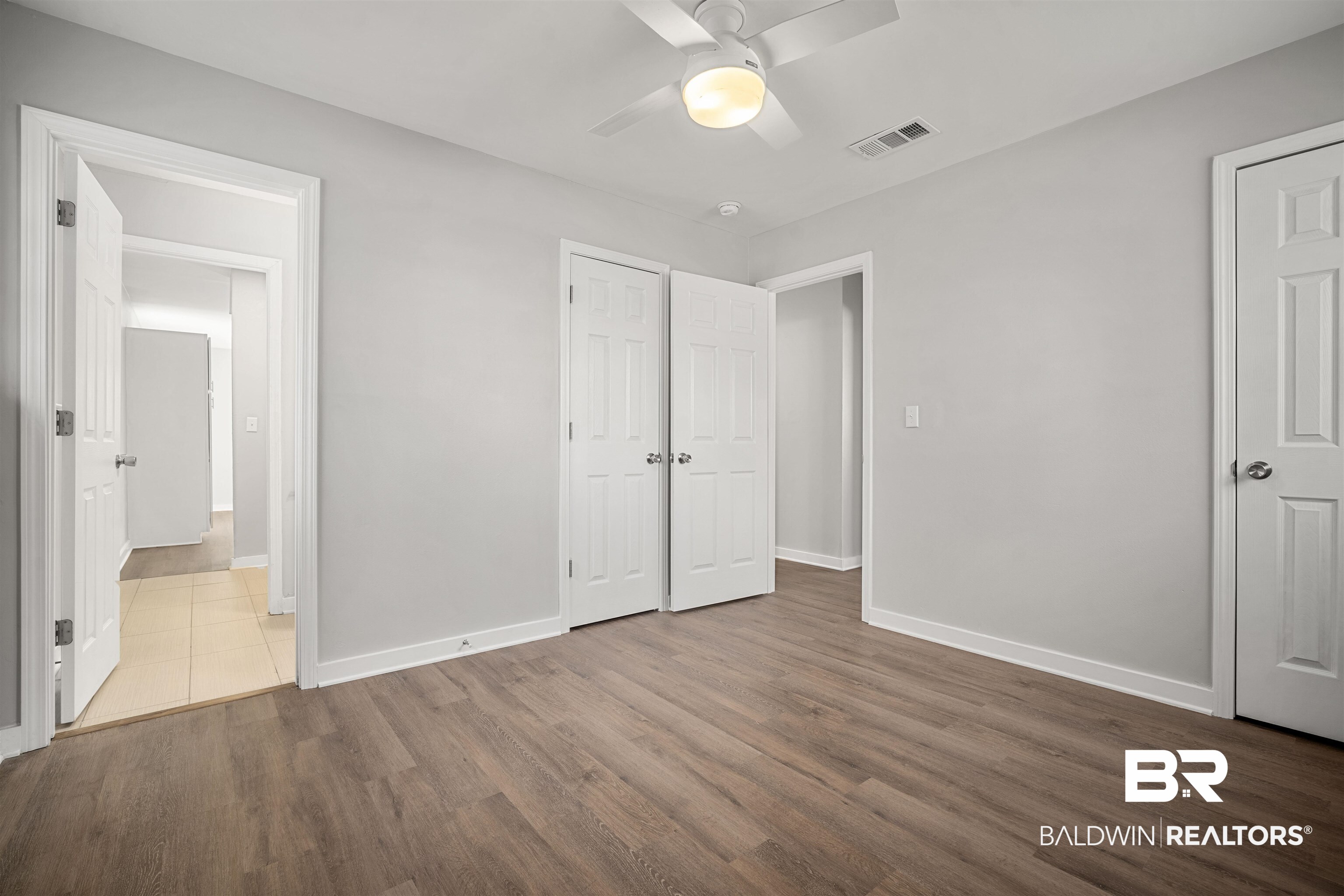 1368 Hubert Pierce Road Mobile, AL 36608 - Photo 14 of 25 Unfurnished bedroom featuring wood finished floors and a ceiling fan