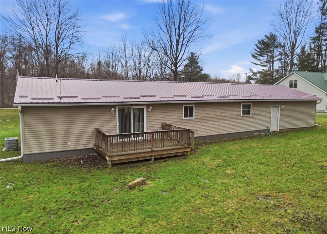 4132 Benetka Road Ashtabula, OH 44004 - Photo 3 of 20 Back of house with a yard, a metal roof, and a wooden deck