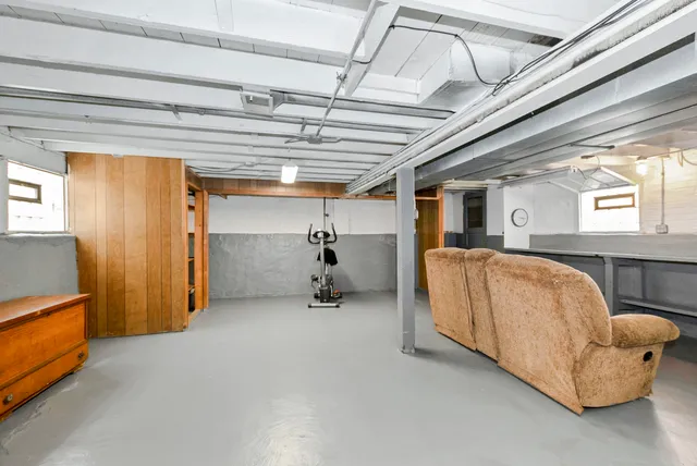 a bed room with a bed and a chair