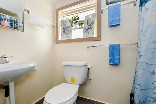 a white toilet sitting next to a bathroom sink
