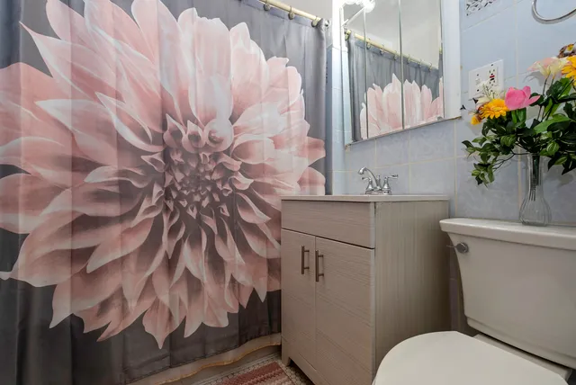 a bathroom with a sink toilet and mirror