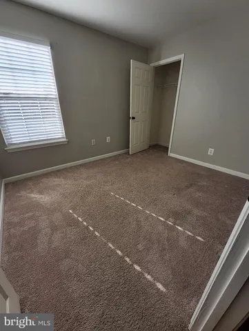 a view of an empty room with windows