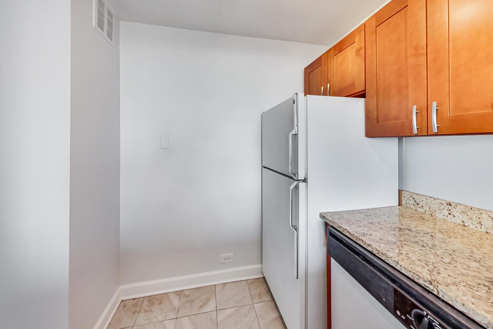 655 West Irving Park Road, Unit 5405 Chicago, IL 60613 - Photo 11 of 31 a kitchen with a sink and a refrigerator