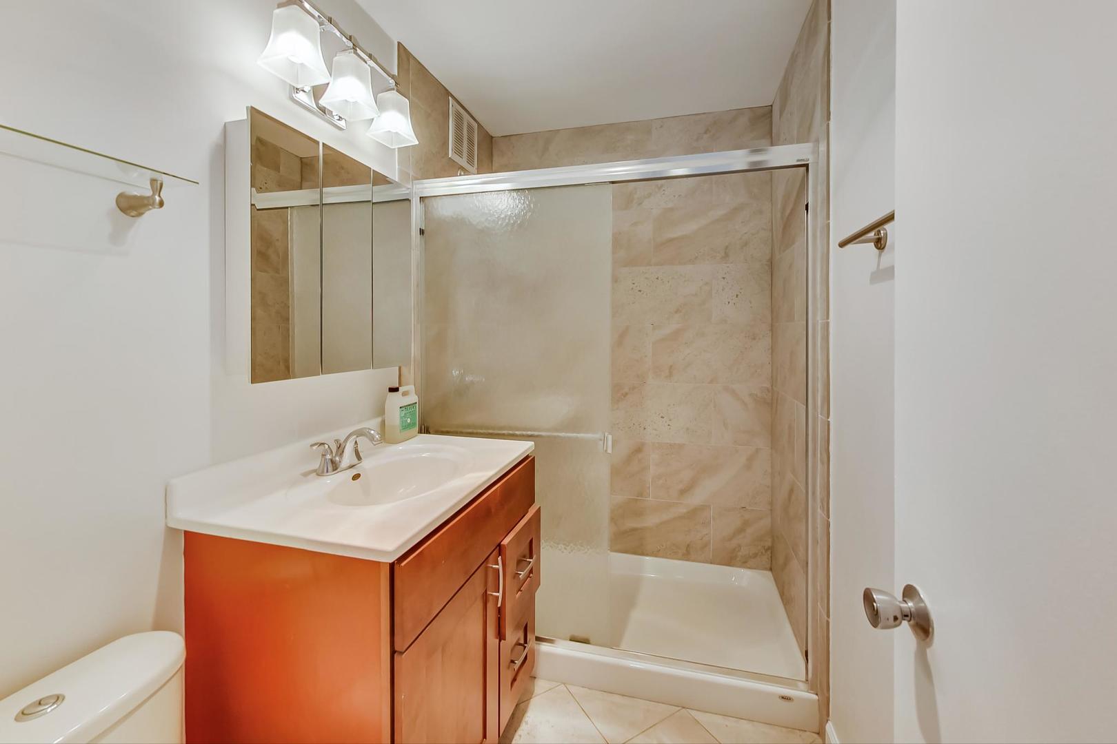 655 West Irving Park Road, Unit 5405 Chicago, IL 60613 - Photo 12 of 31 a bathroom with a sink and shower
