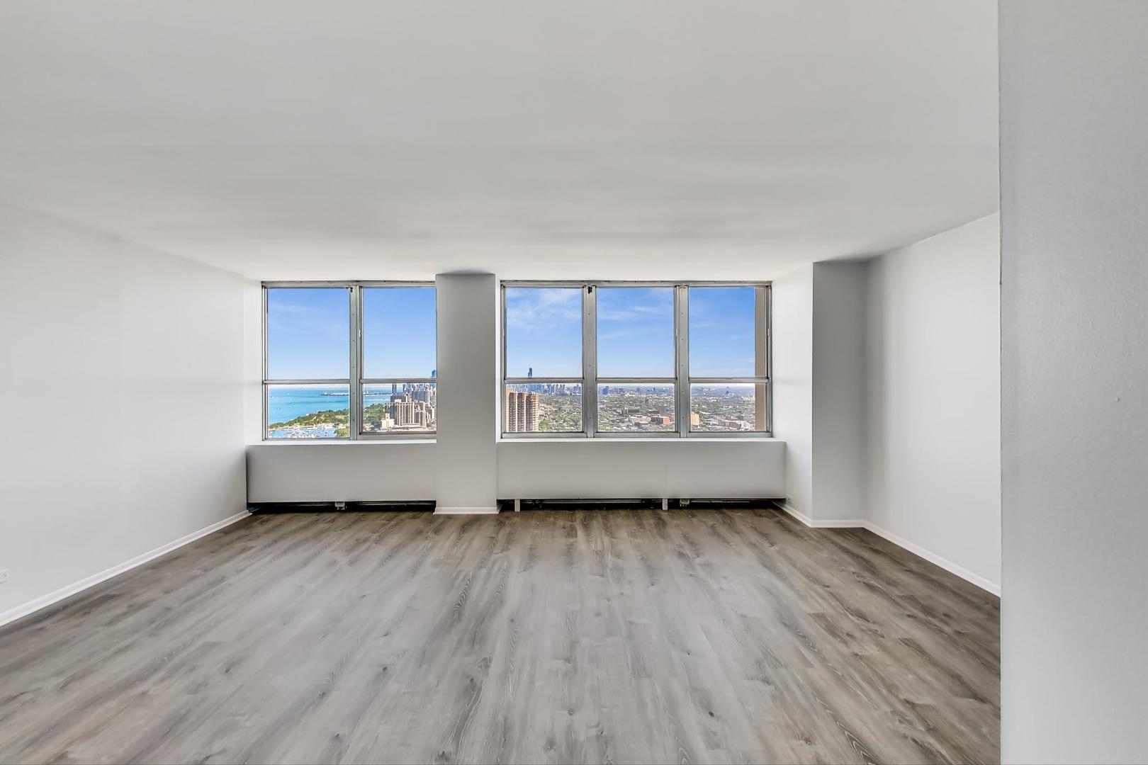 655 West Irving Park Road, Unit 5405 Chicago, IL 60613 - Photo 5 of 31 a view of a room with wooden floor and window