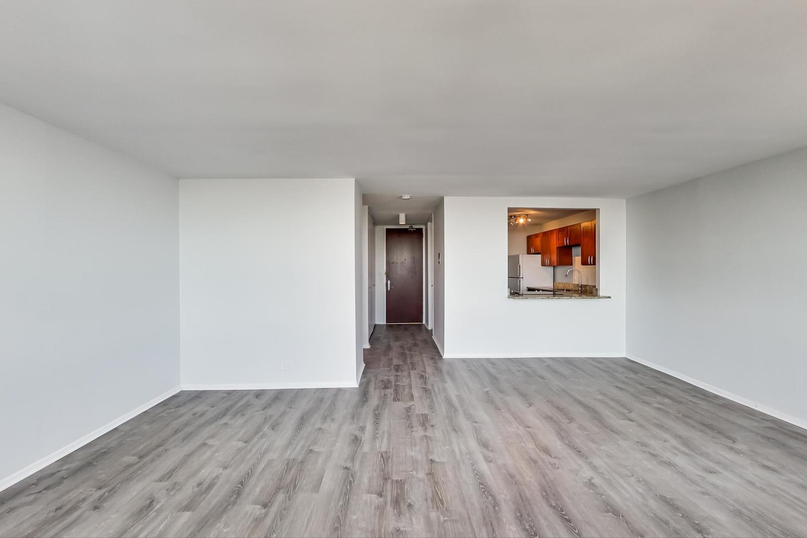 655 West Irving Park Road, Unit 5405 Chicago, IL 60613 - Photo 8 of 31 a view of an empty room and wooden floor