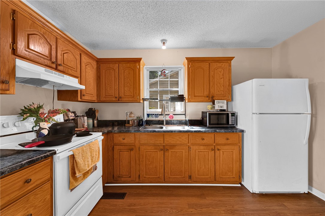 1020 Elizabeth Street Anderson, SC 29624 - Photo 10 of 22 A well-equipped kitchen features solid wood cabinetry and all essential appliances for daily living.