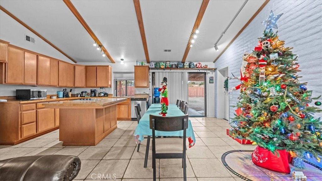 16043 St Timothy Road Apple Valley, CA 92307 - Photo 11 of 48 a living room with a couch and a potted plant