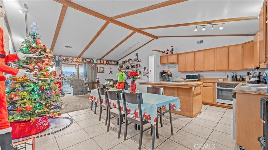 16043 St Timothy Road Apple Valley, CA 92307 - Photo 12 of 48 a view of a dining room with furniture kitchen and chandelier