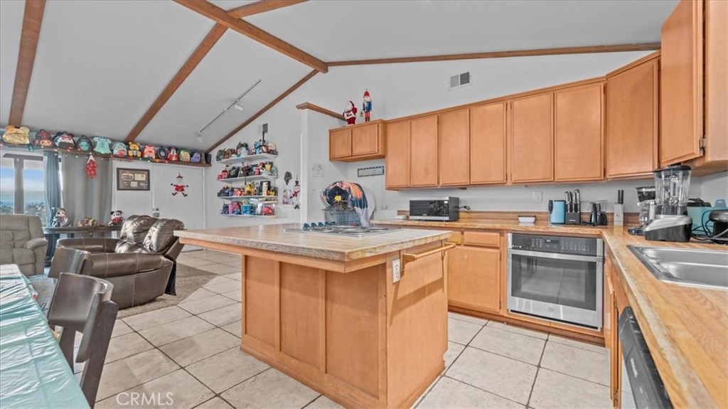 16043 St Timothy Road Apple Valley, CA 92307 - Photo 15 of 48 a kitchen with stainless steel appliances granite countertop a sink and cabinets