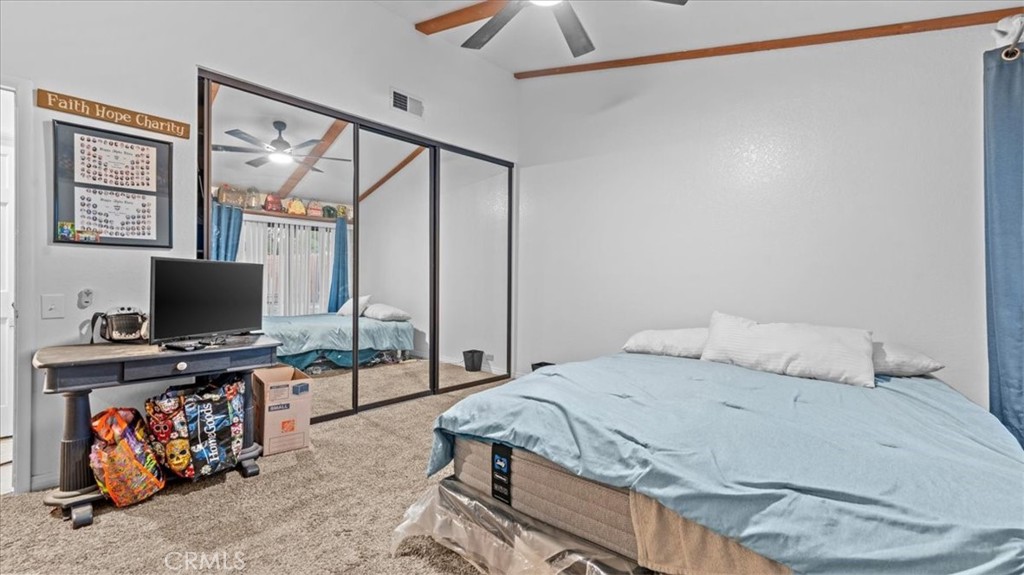 16043 St Timothy Road Apple Valley, CA 92307 - Photo 19 of 48 a bedroom with a bed and a flat screen tv