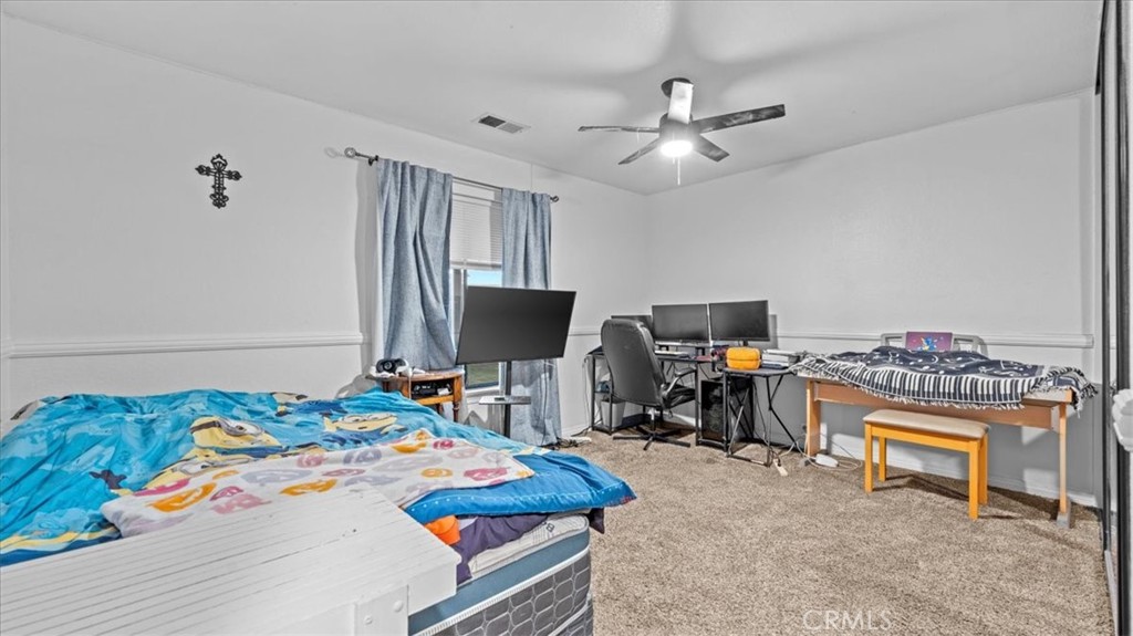 16043 St Timothy Road Apple Valley, CA 92307 - Photo 25 of 48 a bedroom with a bed and a flat screen tv