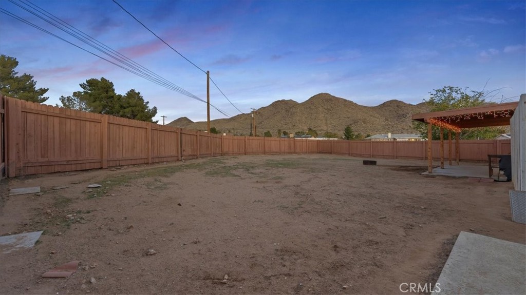 16043 St Timothy Road Apple Valley, CA 92307 - Photo 29 of 48 a view of a backyard with a large tree